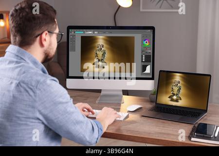 Designer working on different computers at table in office Stock Photo