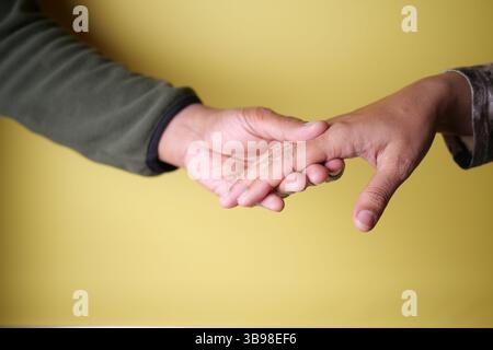 Two hands reaching out to each other in a warm exchange Stock Photo