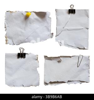 Old reused note paper with pin and paperclips isolated on white background with clipping path Stock Photo