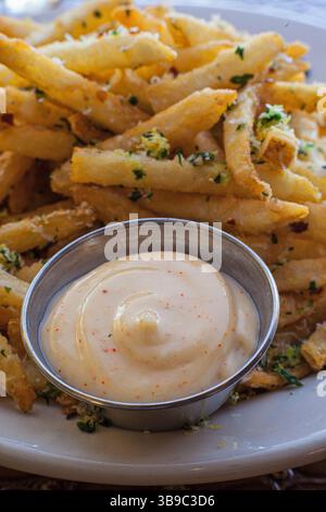Seasoned french fries with aioli dipping sauce vertical Stock Photo