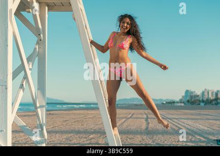 Joyful woman enjoying sunny beach day Stock Photo