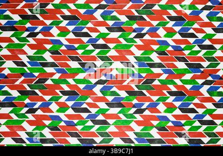 This image presents a vibrant, abstract geometric pattern composed of various colored shapes and angles. The design features a dynamic arrangement. Stock Photo