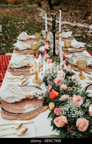 Boho Picnic Setup with Candles and Floral Arrangements for Wedding Stock Photo