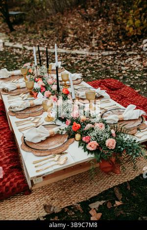 Boho Fall Wedding Picnic on Rug with Fresh Florals Stock Photo