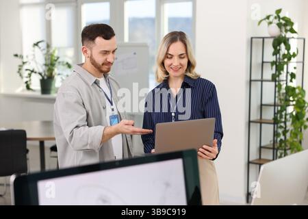 Engineers working together with laptop in office Stock Photo