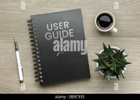 User Guide catalog, cup of coffee, pen and potted plant on wooden table, flat lay Stock Photo