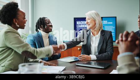 Business, people and handshake in presentation for success of B2B onboarding, machine learning deal or contract. Data scientist, office and shaking Stock Photo