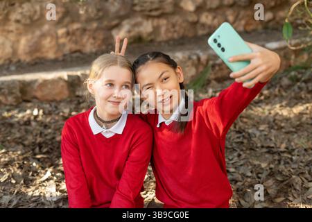 Two students taking a selfie making funny faces Stock Photo