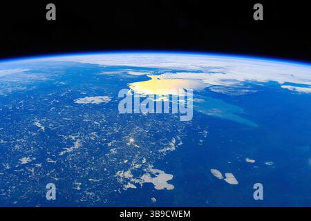 sunlight reflections over sea, planet earth from space. Media usage guidelines: https://www.nasa.gov/nasa-brand-center/images-and-me Stock Photo