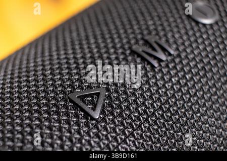 Close-up of button on black mesh portable speaker Stock Photo