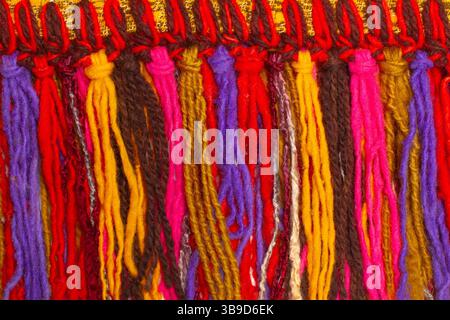 Knotted colored woolen threads in a close up view Stock Photo