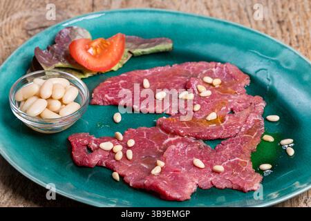 Italian carne salada on a green plate Stock Photo