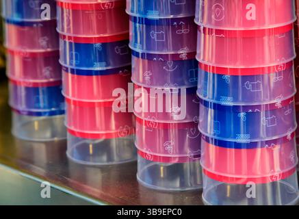 Many stacked colourful plastic drinking cups Stock Photo