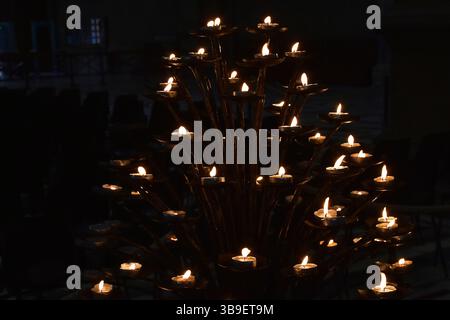 A stand with sacrificial candles in an Italian church Stock Photo