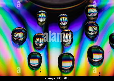 Water drops on a CD create an explosion of colour Stock Photo