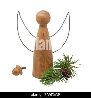 Turned wooden angel figure decorated with pine cones and pine needles Stock Photo