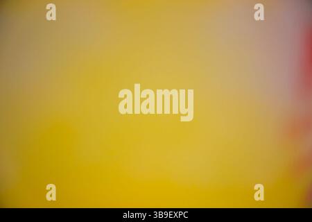Blurred gradient of yellow and orange creating a soft background Stock Photo