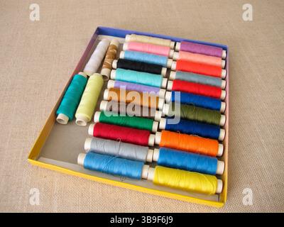 Sewing thread in different colours in a box Stock Photo