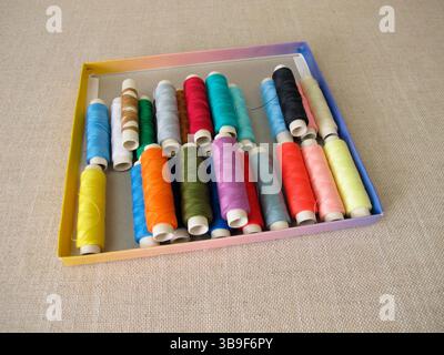 Sewing thread in different colours in a box Stock Photo