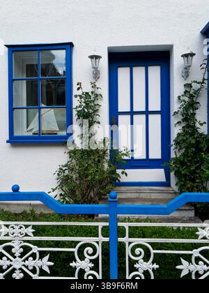 White plastered house with blue accents Stock Photo
