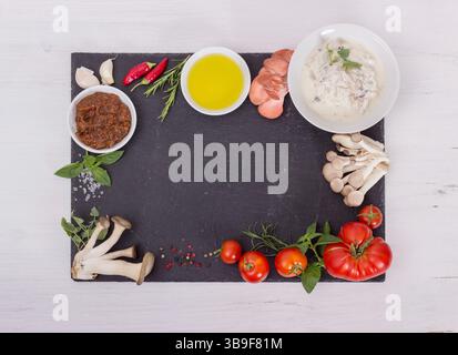 Fresh ingredients of the Mediterranean cuisine on a black plate Stock Photo