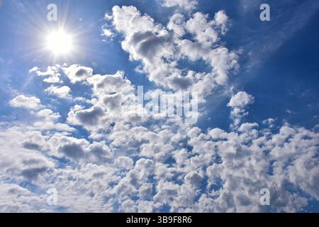Bright sun between the clouds Stock Photo