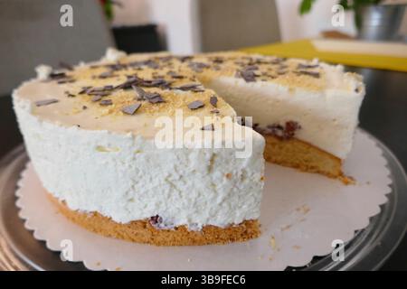 Sliced cheesecake with raspberries, chocolate chips and lemon Stock Photo