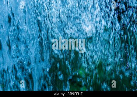 Falling water blurred in blue Stock Photo
