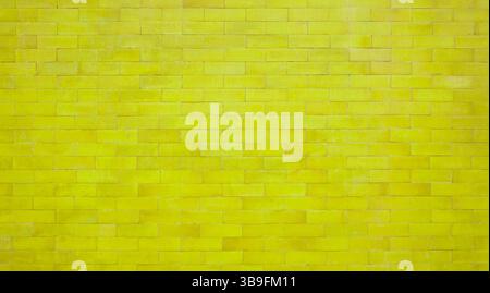 Yellow brick wall with stones - brick wall as background Stock Photo