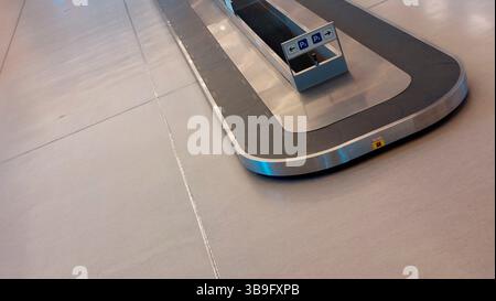 Empty baggage carousel in the arrivals hall at the airport Stock Photo