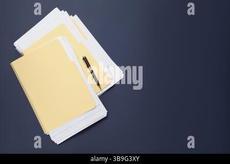 File folders with papers and pen on dark blue background, top view. Space for text Stock Photo