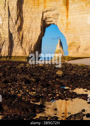 The Needle seen through the arch of the Manneporte cliff in Etretat ...