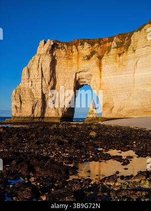 The Needle seen through the arch of the Manneporte cliff in Etretat ...