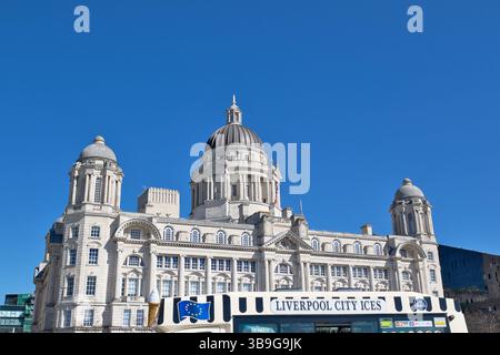 The image shows the Port of Liverpool Building under a blue sky, with a Liverpool City Ices vehicle in the foreground. Stock Photo