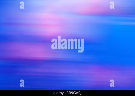 A vivid and abstract image featuring blurred colorful streaks in shades of blue, pink, and purple, ideal as a dynamic background. Stock Photo