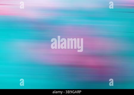 This image features a vibrant, abstract blurred background with motion effects in shades of pink, blue, and green, ideal for creating visually strikin Stock Photo