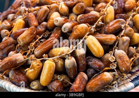 Close-up of selected dried dates on plate. Natural oriental sweets. Stock Photo