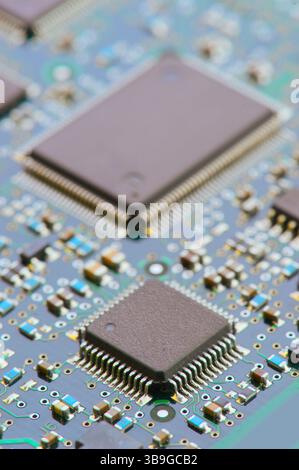 Close-up image depicting the intricate details of an electronic motherboard, showcasing various components such as microchips, capacitors, and connect Stock Photo