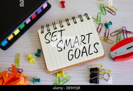 Set smart goals symbol. Concept words Set smart goals on white notebook. Beautiful wooden background. Business and Set smart goals concept. Copy space Stock Photo