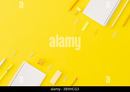 Back to school concept, school supplies and accessories on yellow background, notebook, pencils, paperclip, duster, flat lay copy space Stock Photo