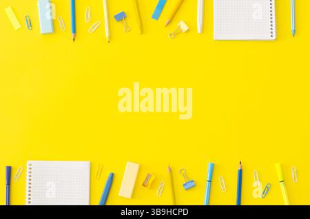 Back to school concept, school supplies and accessories on yellow background, notebook, pencils, paperclip, duster, flat lay copy space Stock Photo