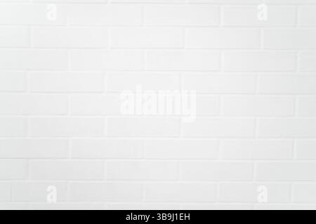 Flat closeup of white painted brick wall texture, showcasing uniform pattern, grout lines, and matte finish ideal for backgrounds or architectural des Stock Photo