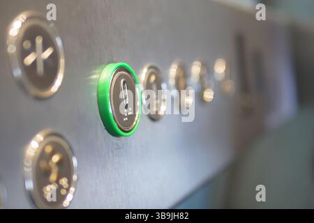Elevator control panel with illuminated button in modern building Stock Photo
