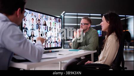 Hispanic Man Leads Professional Online Video Conference With Diverse Team. Stock Photo