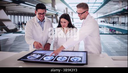 Diverse Group Of Doctors Examining A Brain MRI Scan. Stock Photo