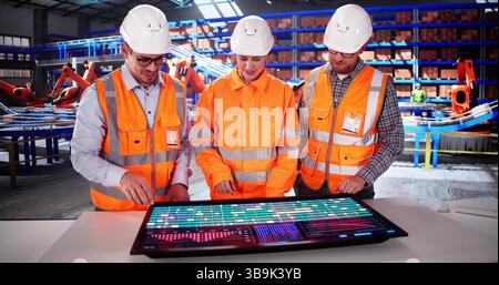 The Young Latino Engineer Using 3D CAD Software In Car Factory Stock Photo