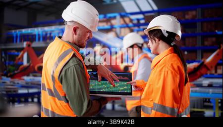 Hispanic Warehouse Engineer Manages Logistics Team Using Laptop For Inspection Stock Photo