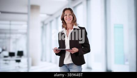 An Indian Businesswoman Using A Tablet Computer In Her Office. Stock Photo