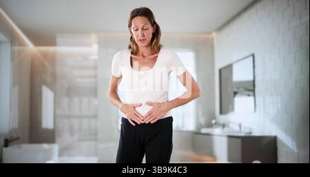 Female Ectopic Pregnancy Causes Nausea, Woman In Pain Seeks Help Stock Photo