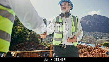 Construction team, collaboration and people shaking hands outdoor for agreement on nature development. Mature man, builder or engineers together for Stock Photo